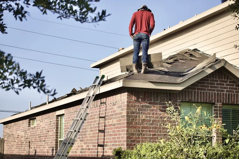 Professional roofer working on a residential roof in Clune